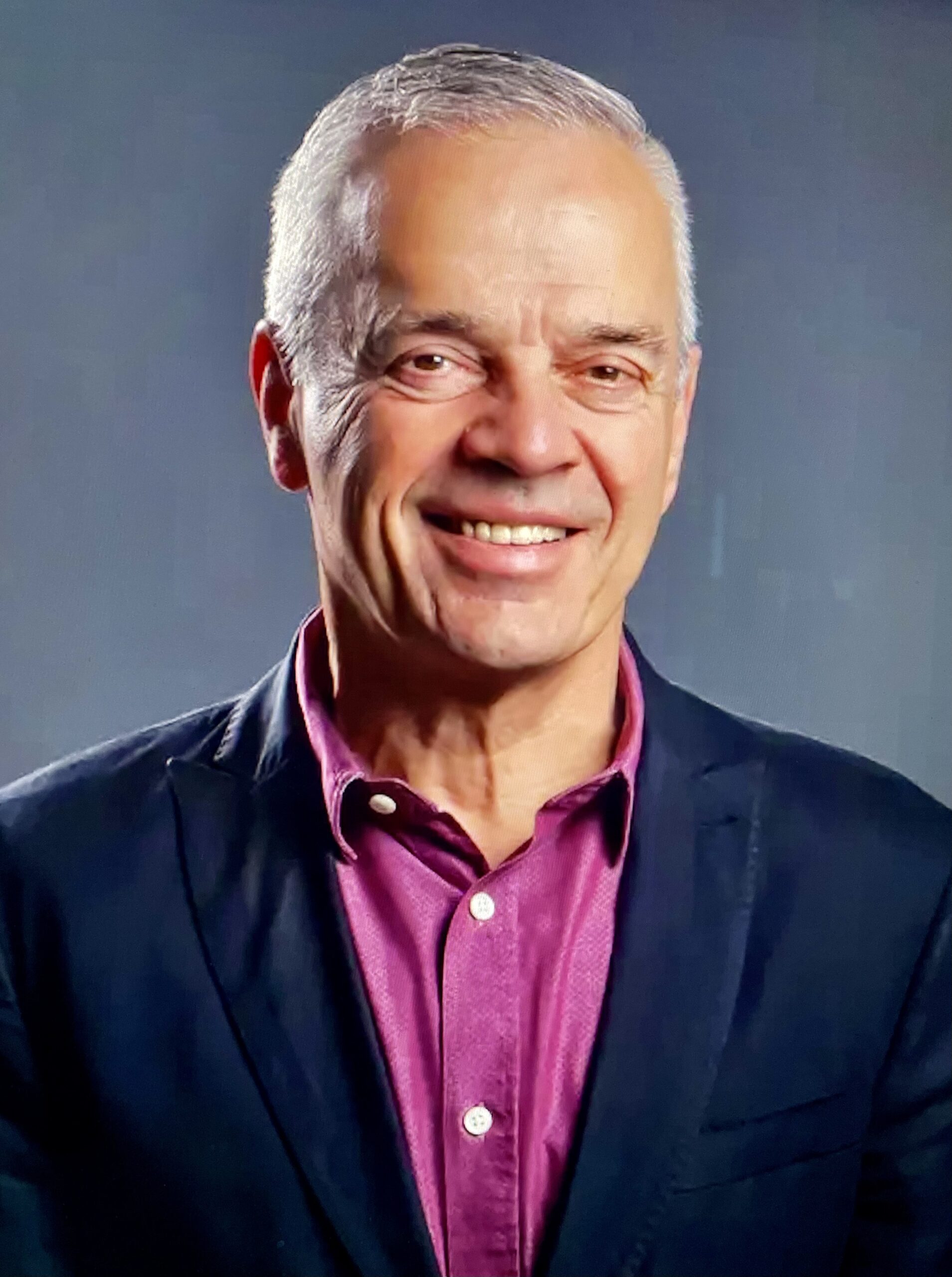 author smiling in a suit